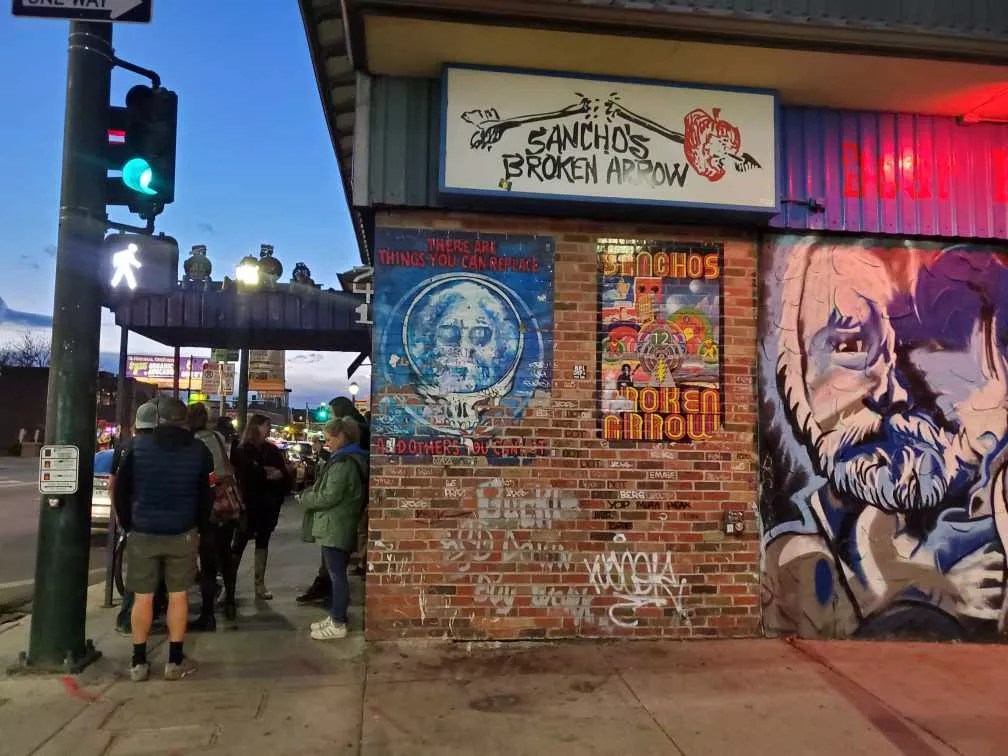 a brick wall with graffiti and street art