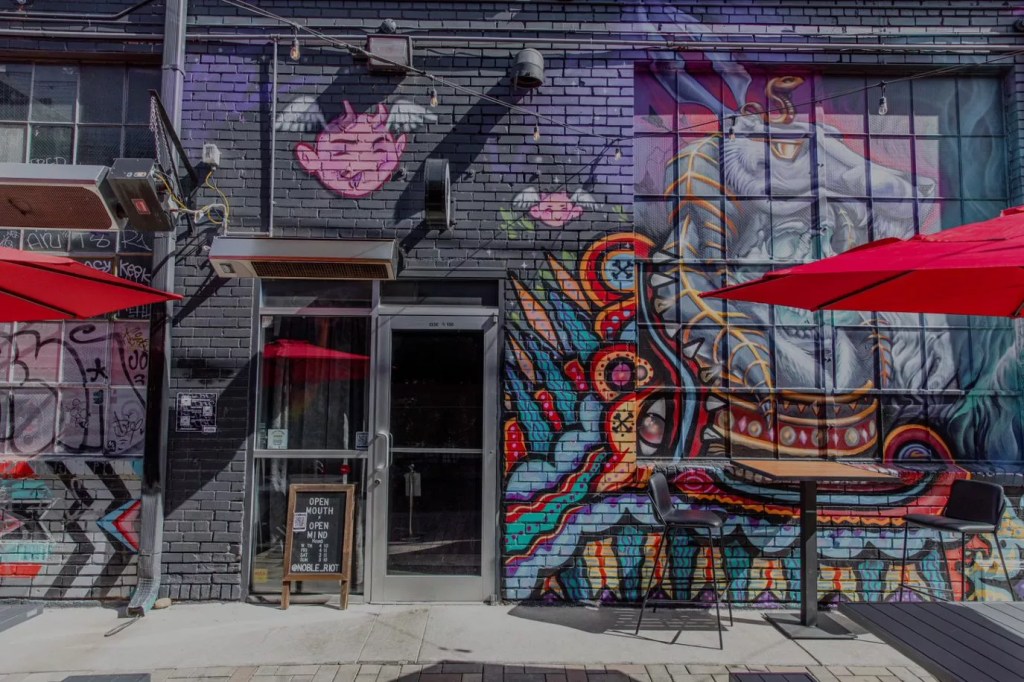 wall with a door and a mural