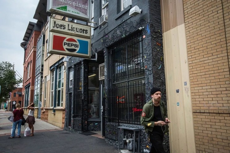 old pepsi sign hanging outside a building