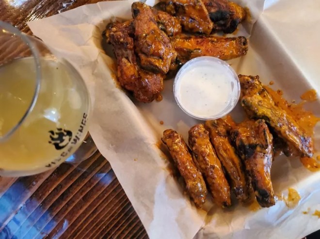 chicken wings and a side of ranch on a tray