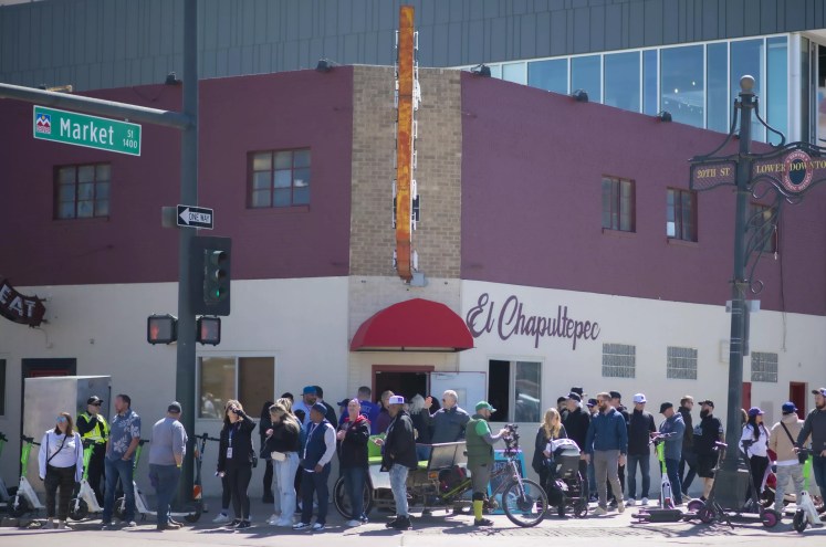 a line outside of a bar