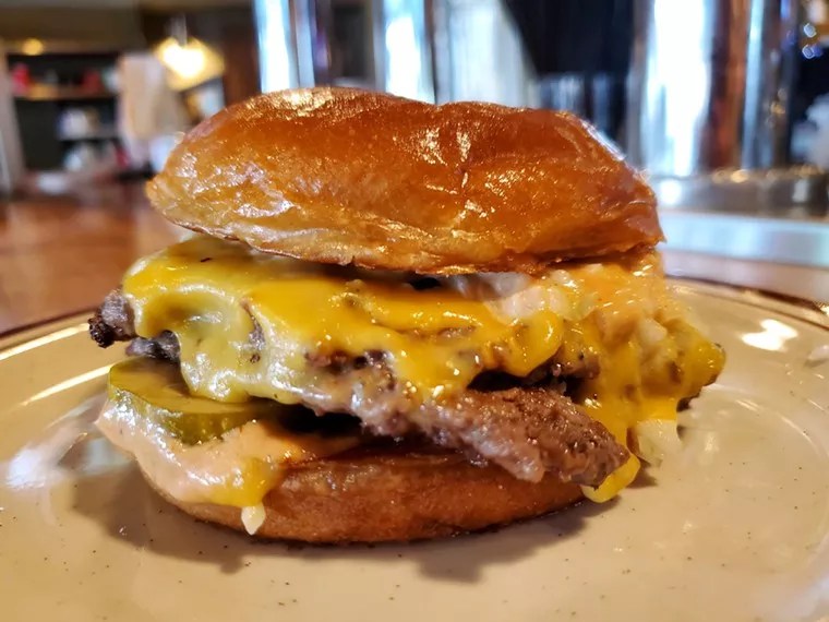 A tantalizing hamburger dripping with cheese