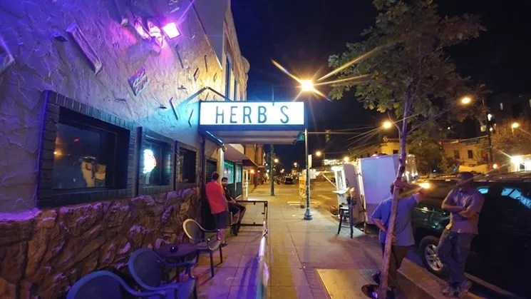 exterior of a dive bar in denver at night