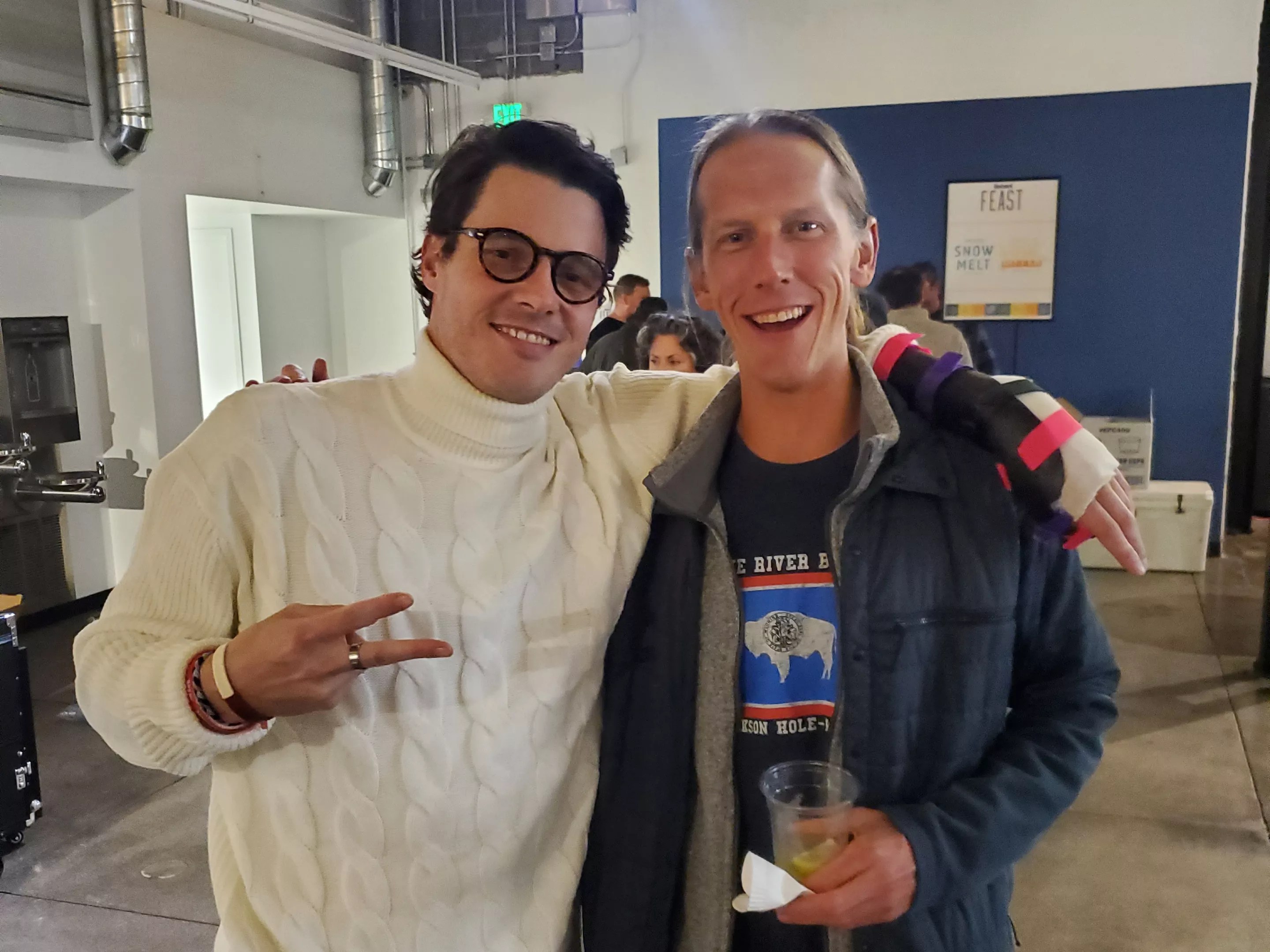 Two men posing and smiling