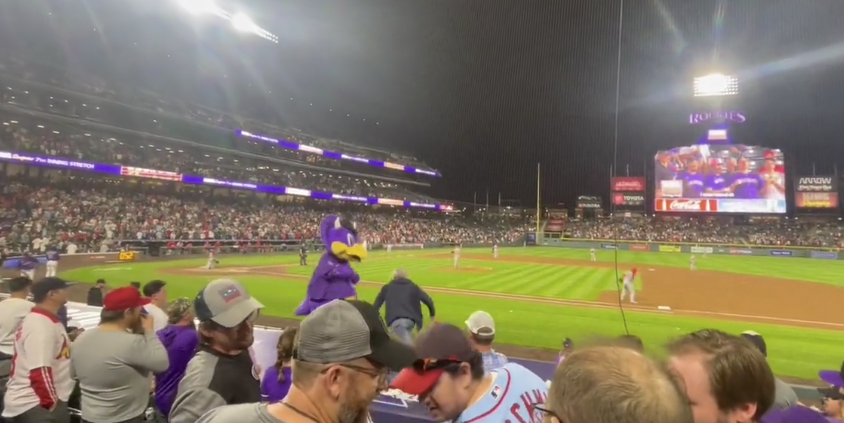 Colorado Rockies mascot Dinger being attacked by a fan