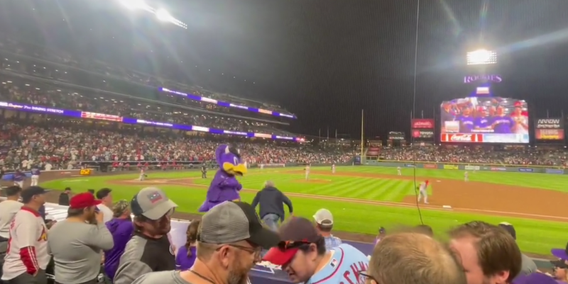 Colorado Rockies mascot Dinger being attacked by a fan