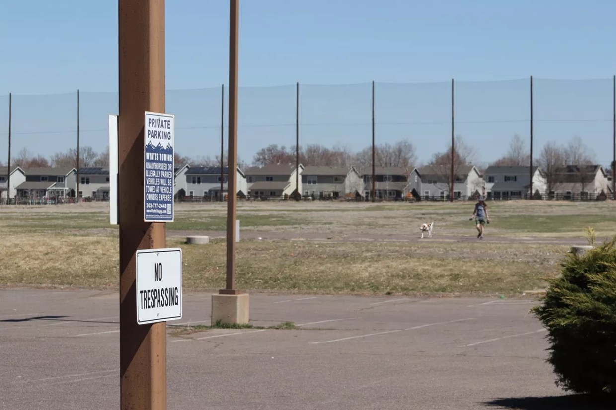 woman walks dog park Hill golf course