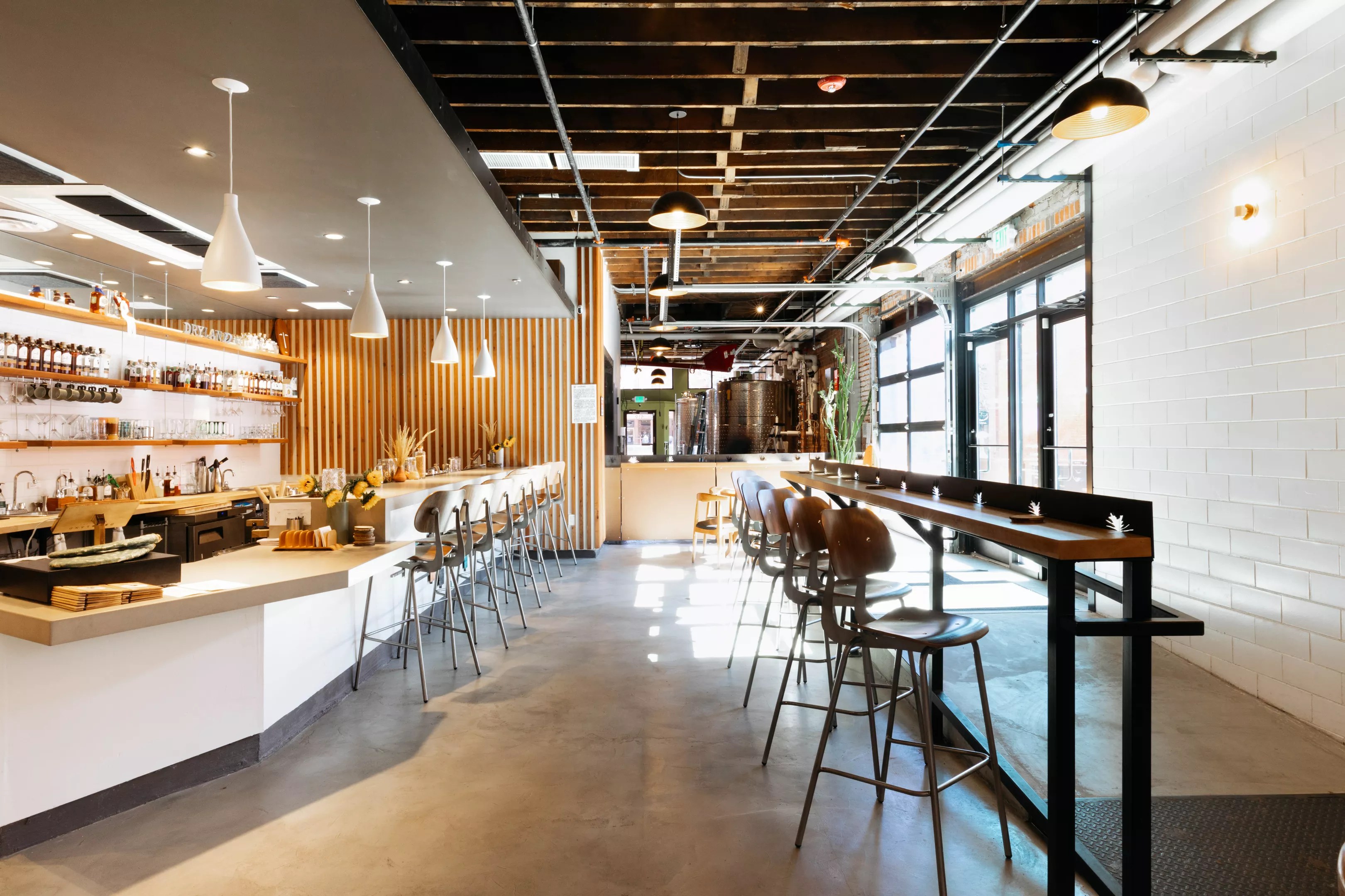 a large open room with a bar and tables