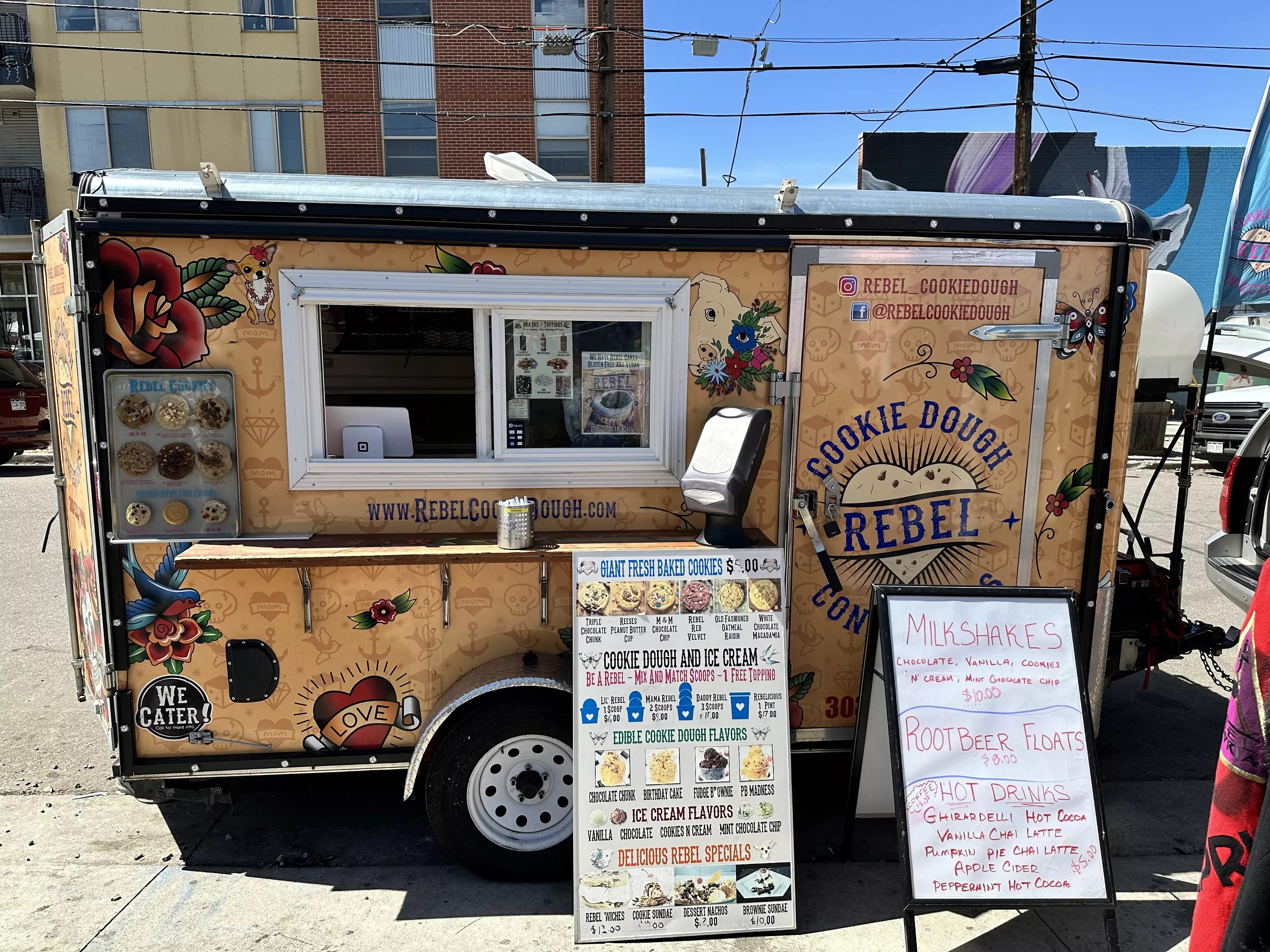 a food truck with a menu board in front of it