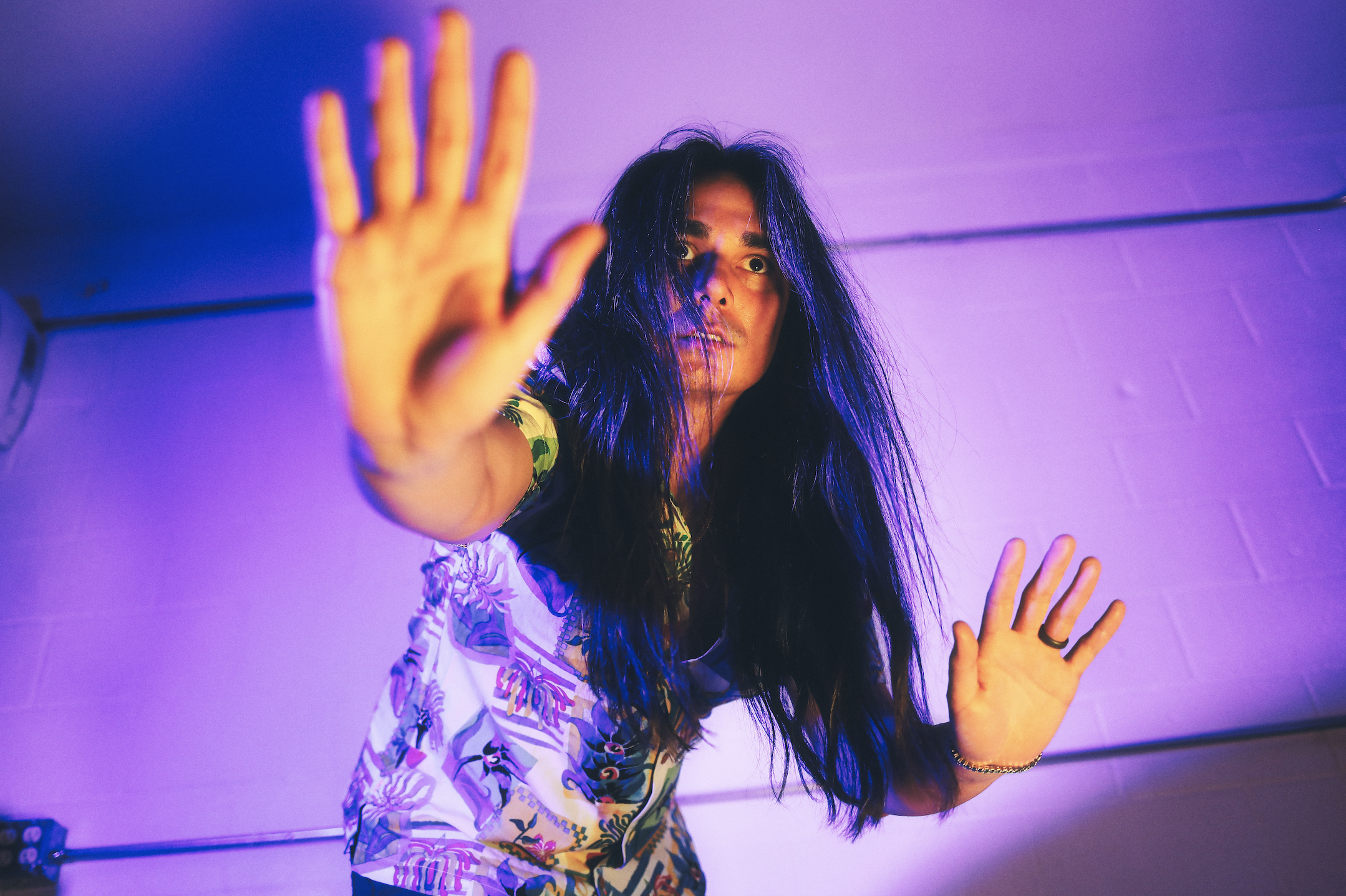 a man posing with his arms out