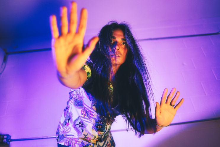 a man posing with his arms out