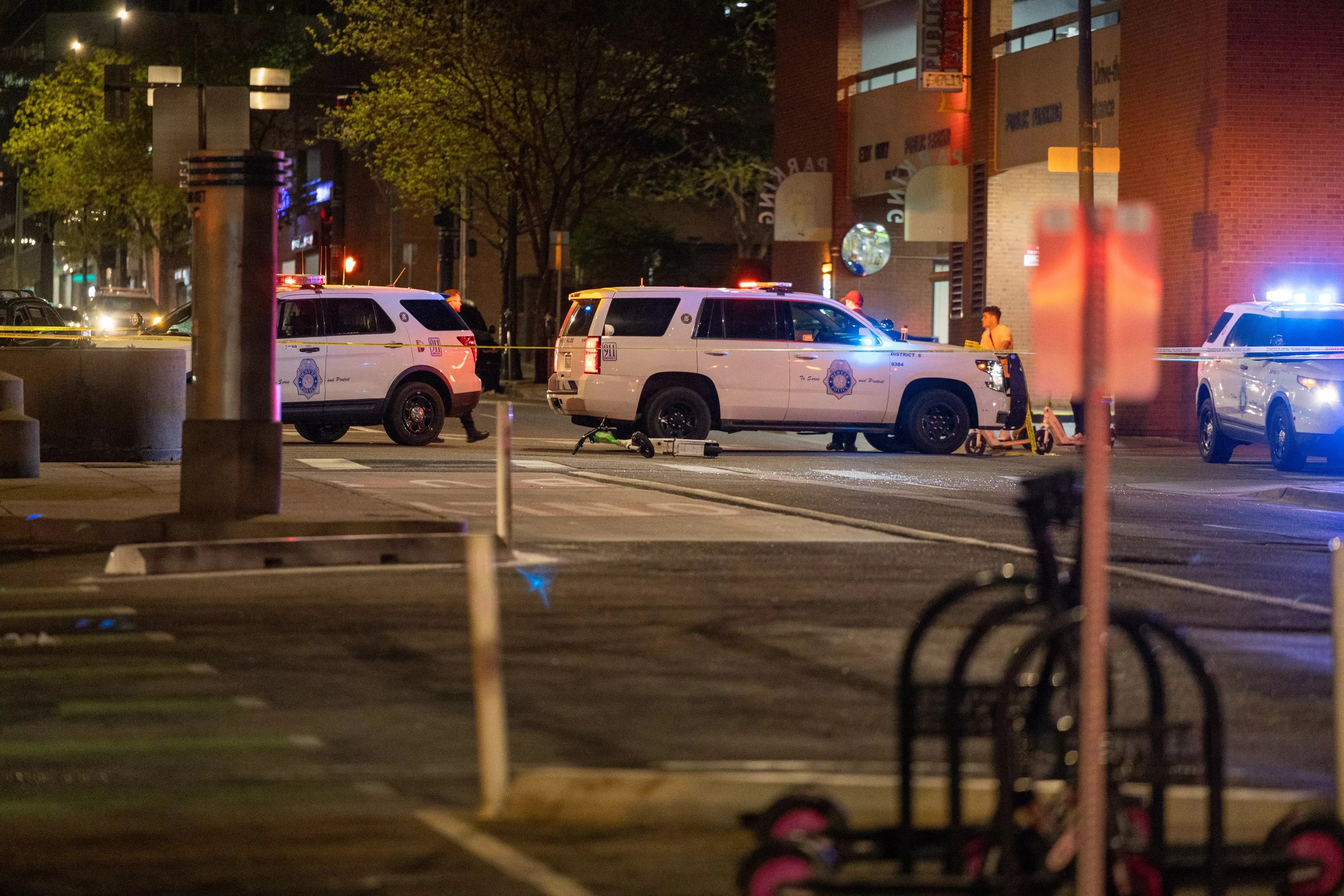 Cops on the scene after a May 7 crash involving a vehicle and two scooter riders.