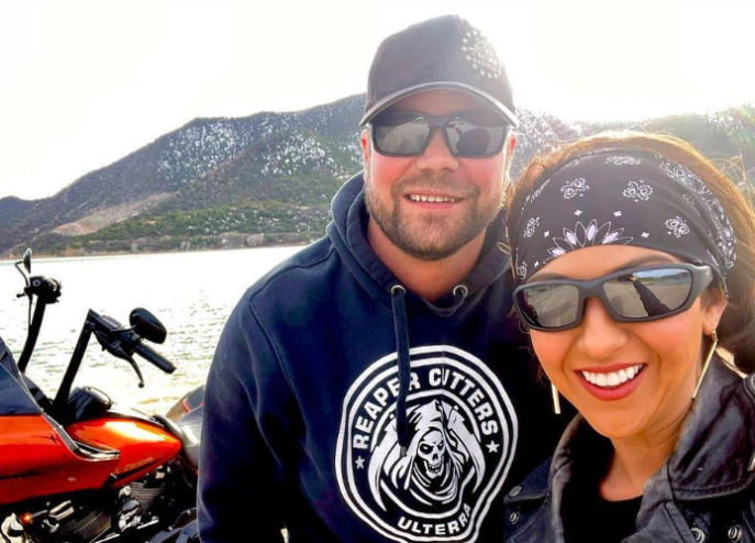 Congresswoman Lauren Boebert and her husband Jayson Boebert in an Instagram photo standing next to a motorcycle.