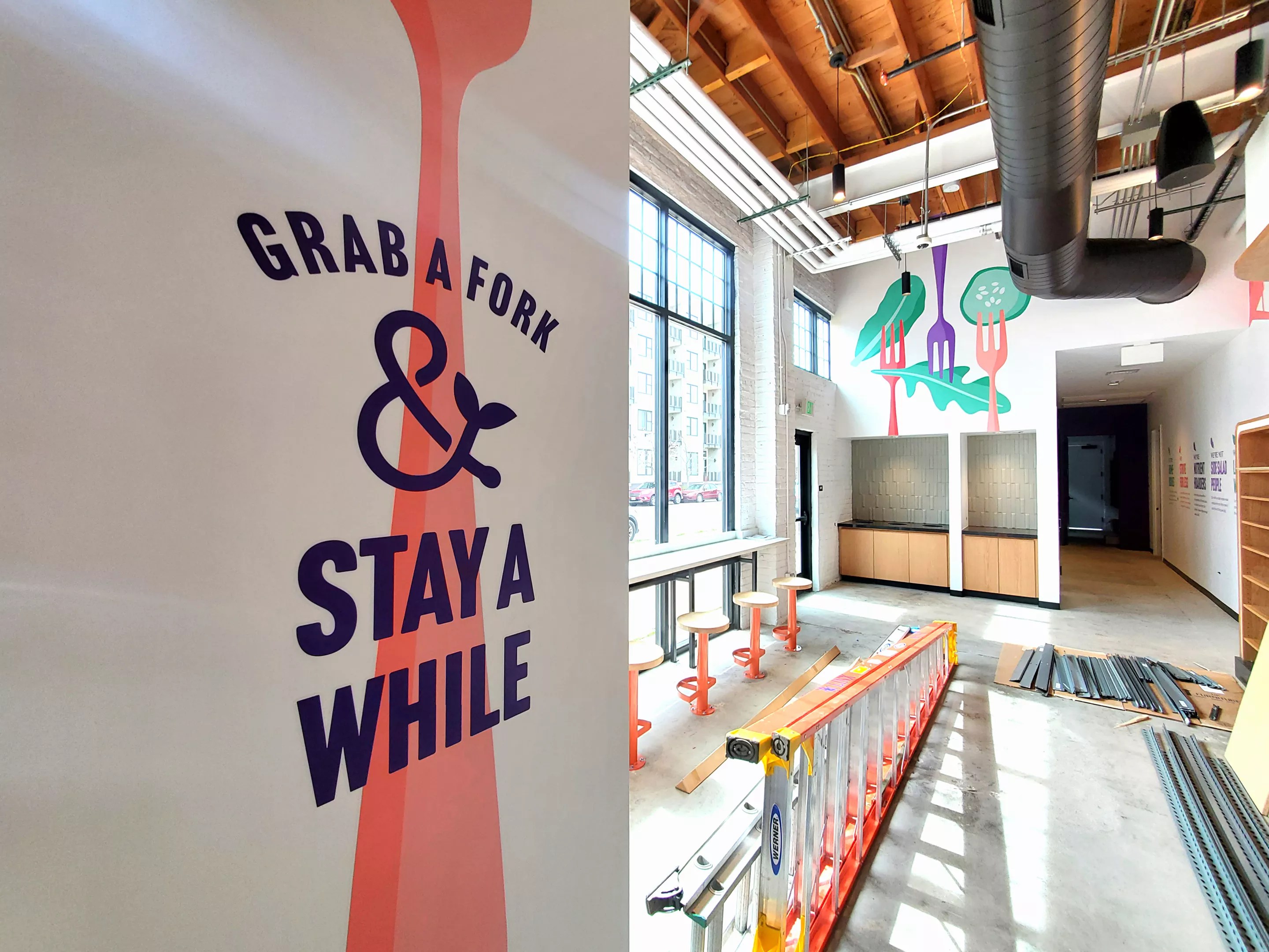 a wall with a decal of a big pink fork