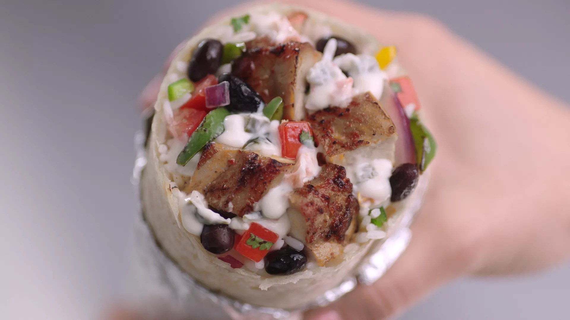 a close up of a burrito cut in half