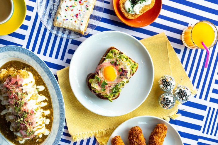 several plates of food on a blue striped table