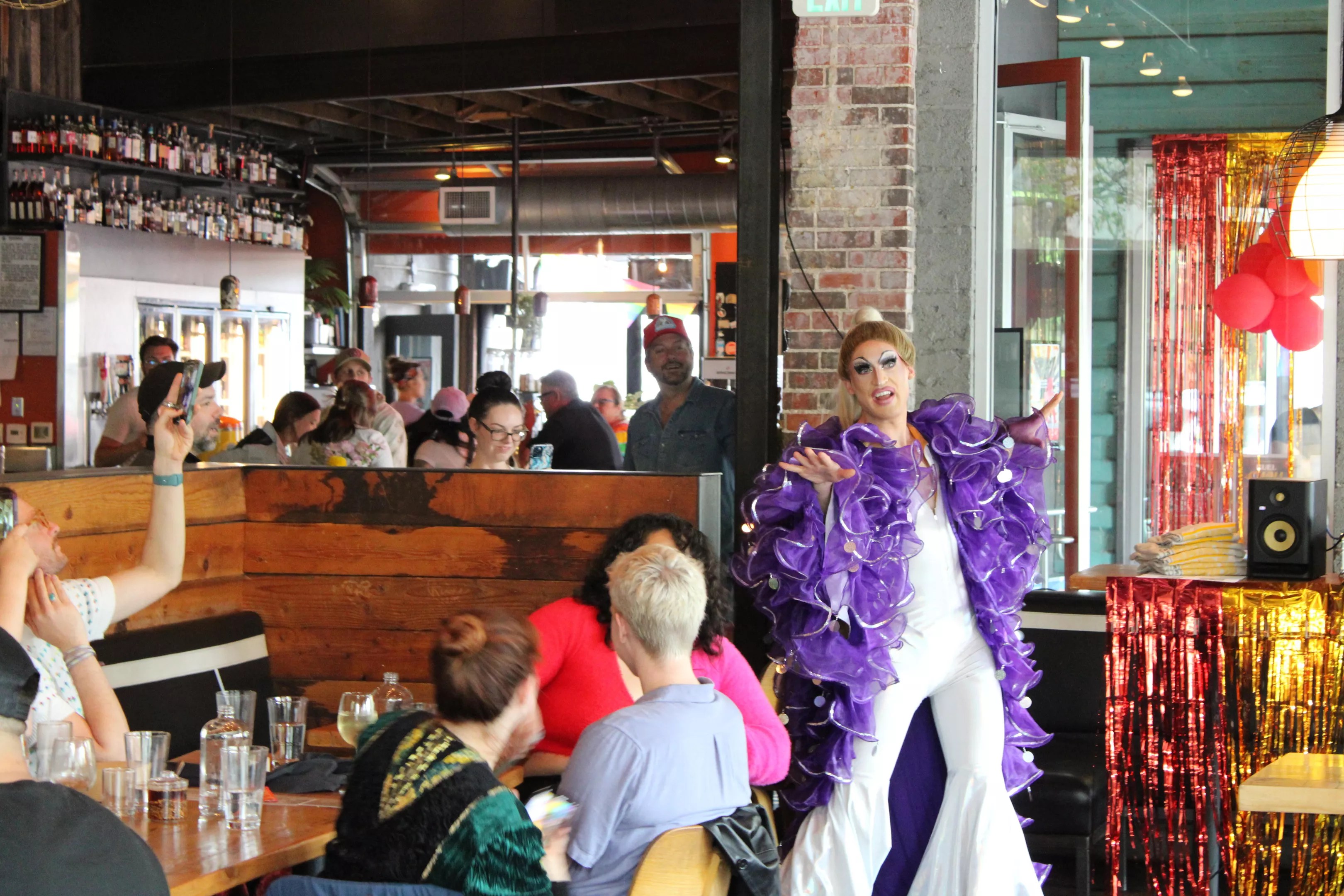 a  drag queen with a purple feather boa