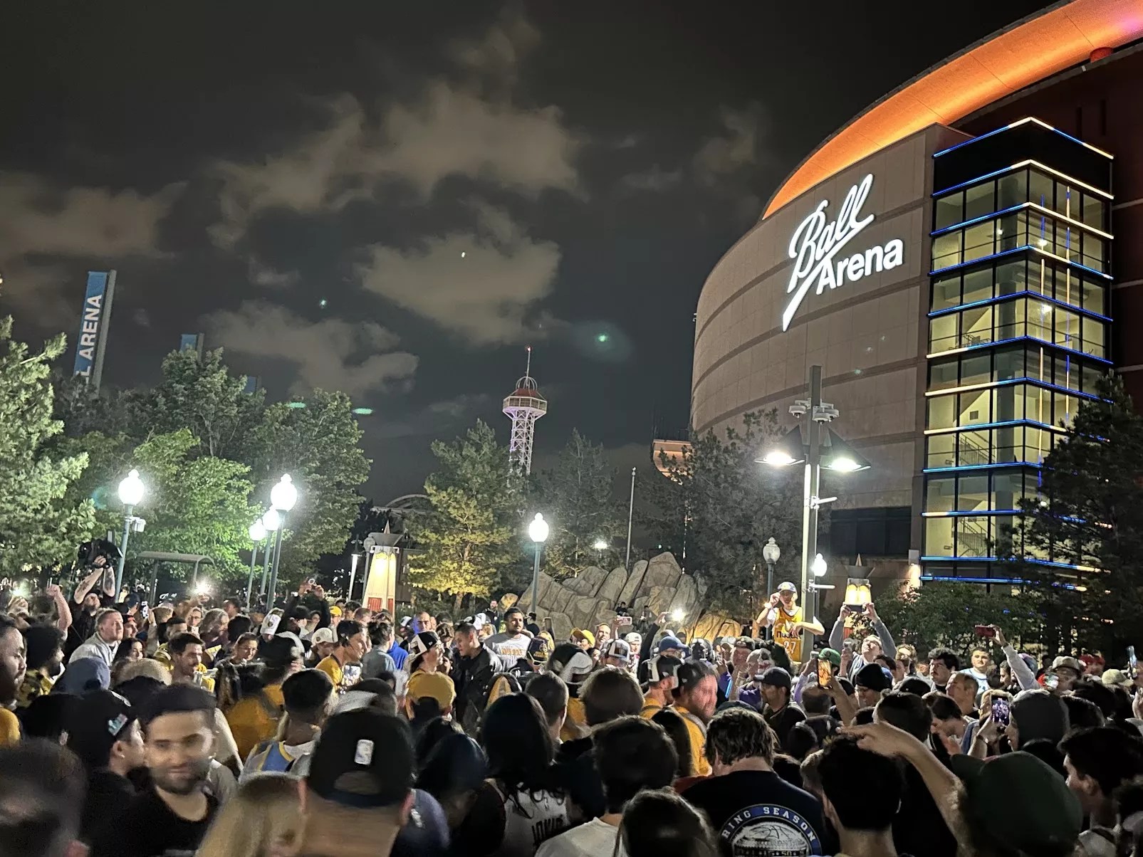 fans celebrating Denver Nuggets win outside Ball Arena.