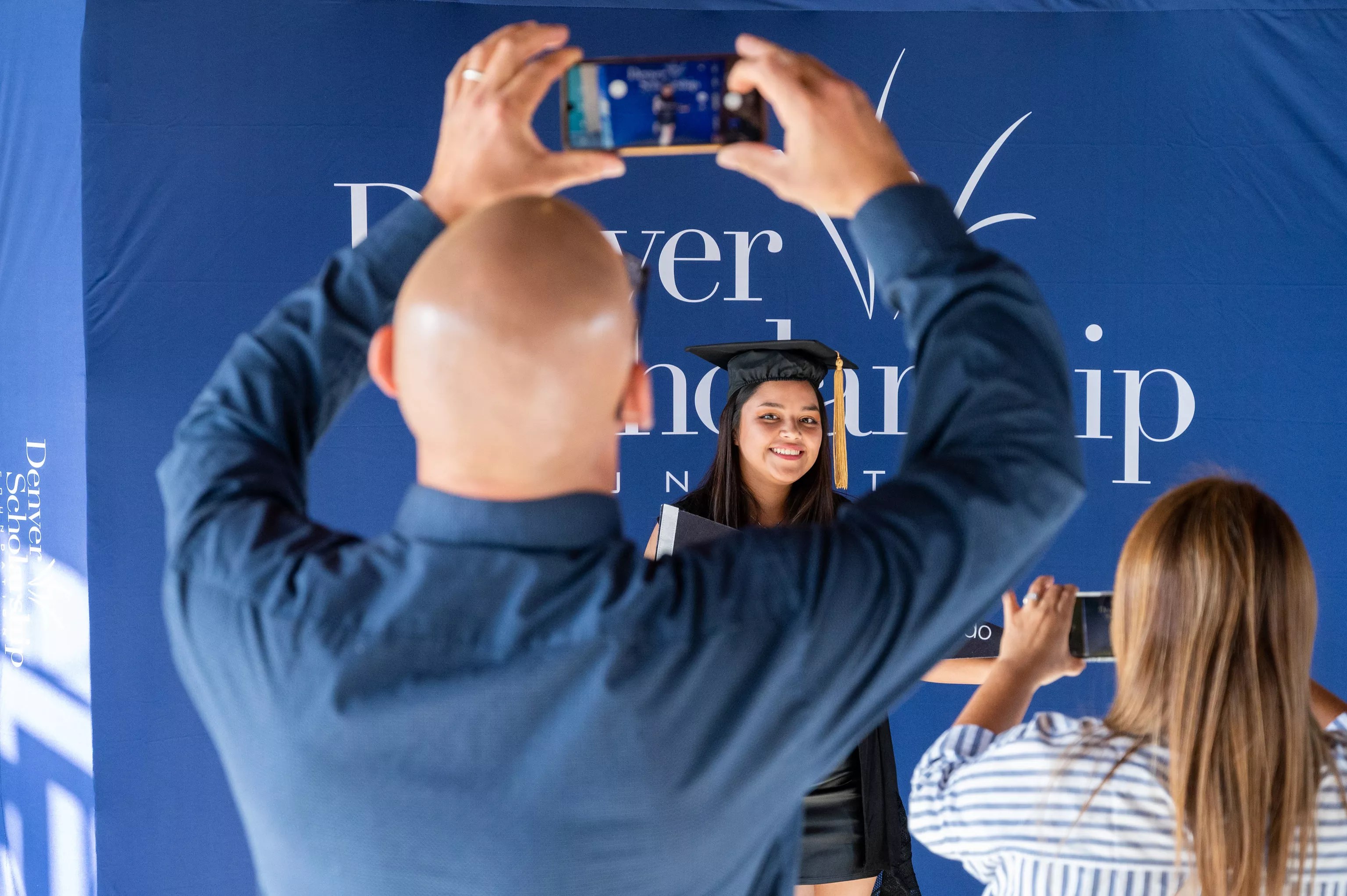 Man taking photograph of graduate