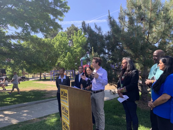 new Denver mayor in park with supporters on transition team