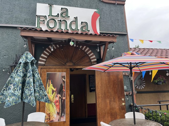 an umbrella in front of the entryway to a restaurant