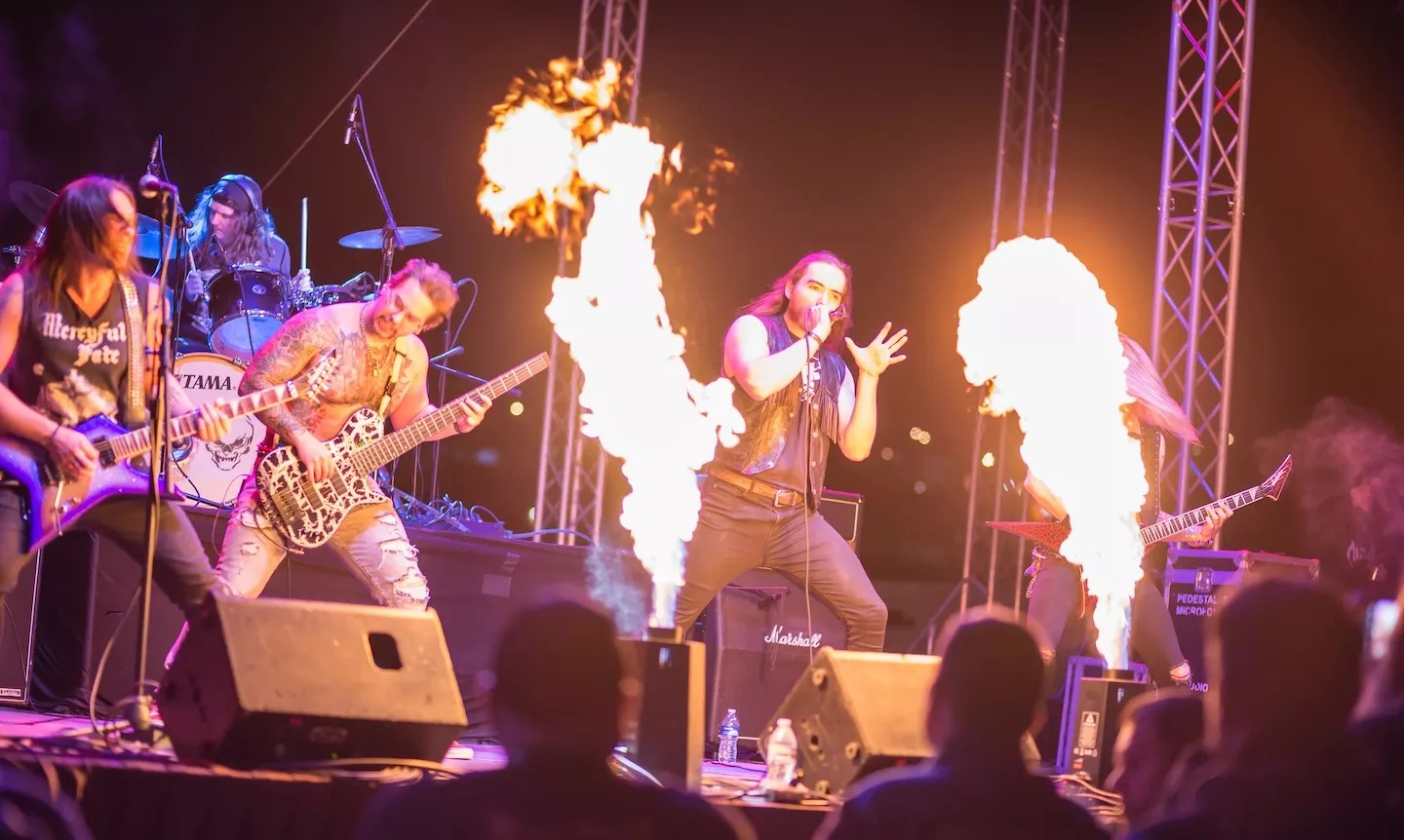 metal band plays on stage with flame throwers