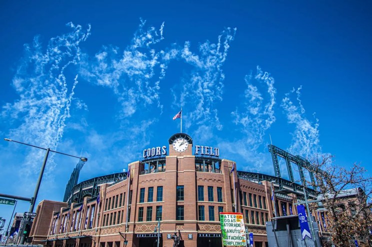 coors field ballpark with sky and smoke from fireworks
