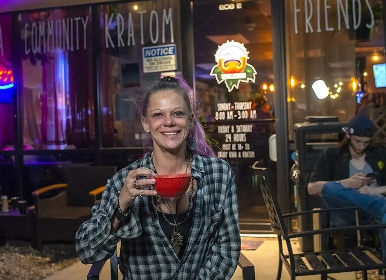 woman with bowl of kava outside bar