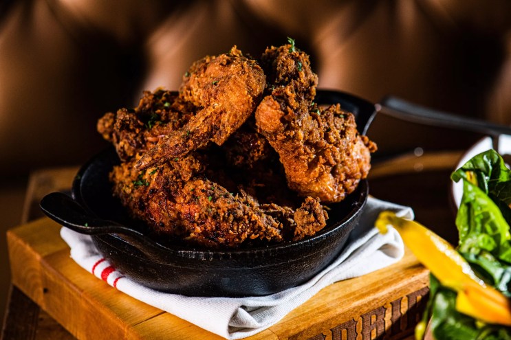 a cast iron skillet filled with fried chicken