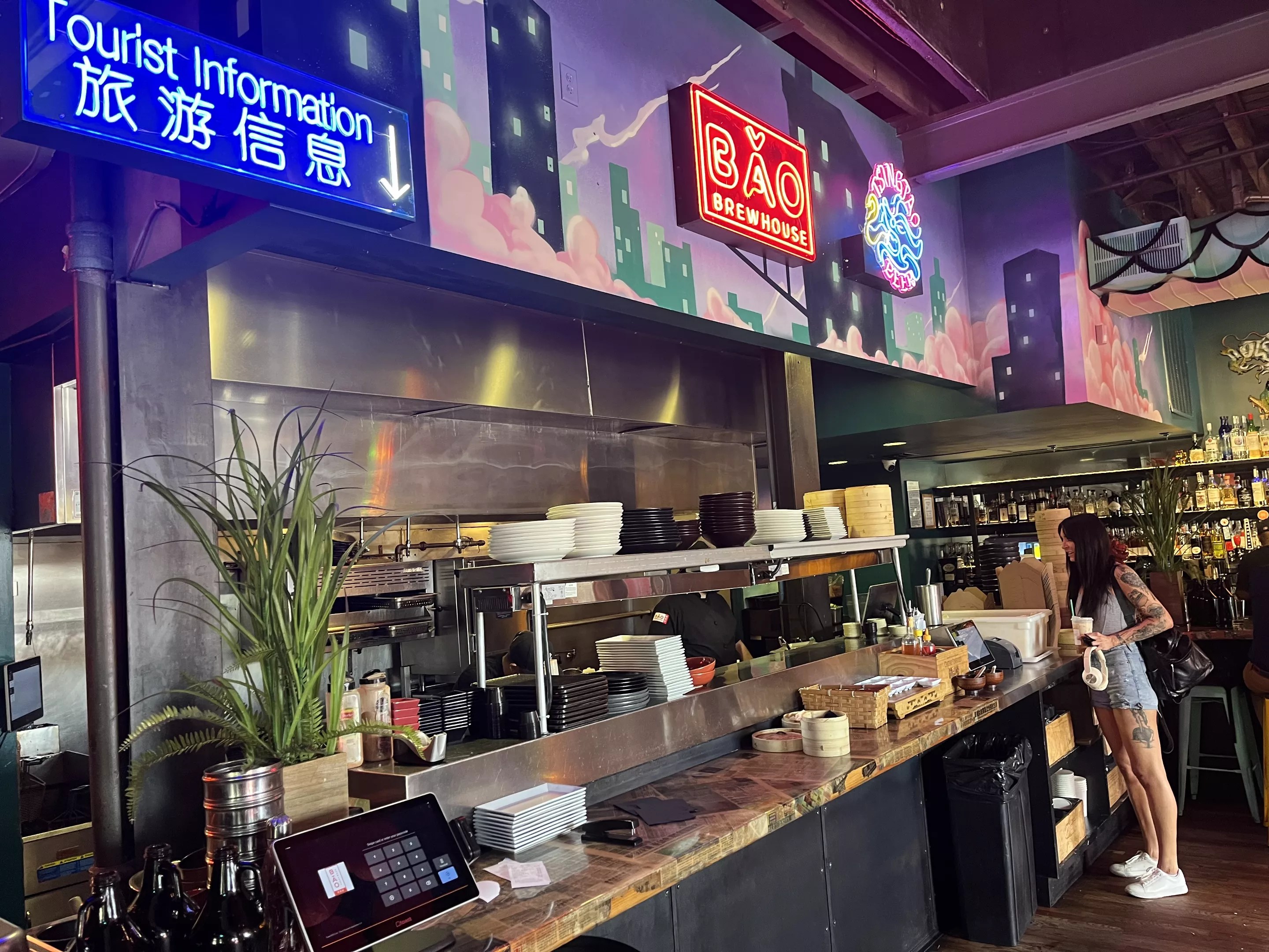 neon signs hanging over a counter at a restaurant