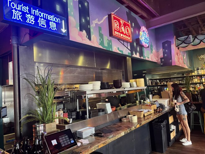 neon signs hanging over a counter at a restaurant