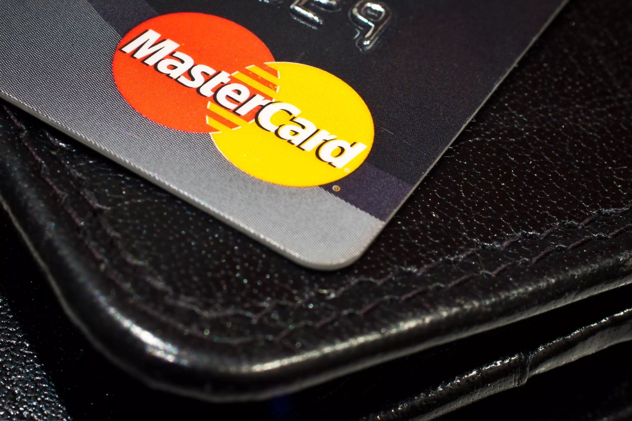 Mastercard credit card on top of leather wallet