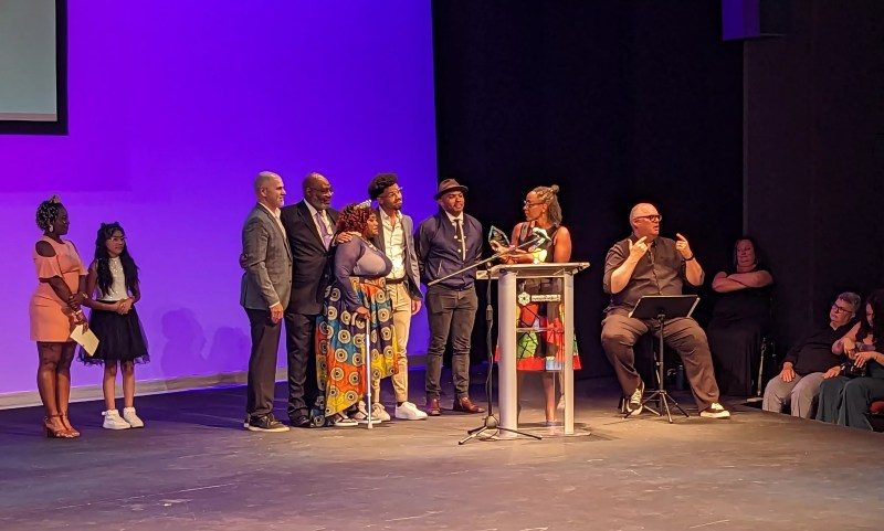 people accepting an award on stage