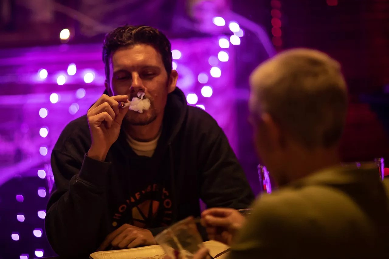 A man smokes a joint at a cannabis party in Denver