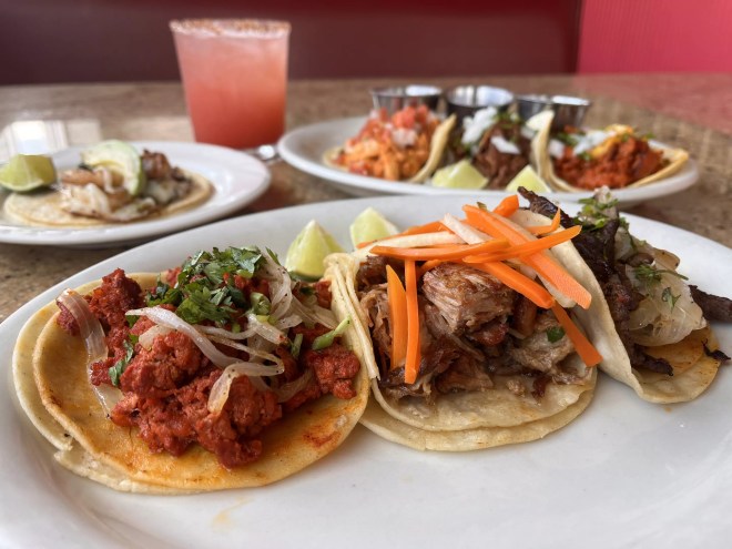 a variety of tacos on a plate