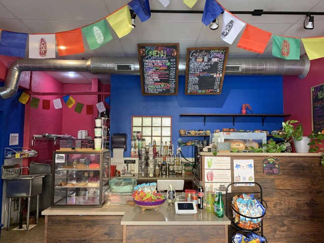 a counter in a coffee shop with colorful walls