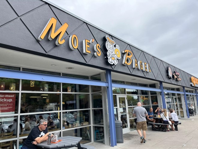 a bagel shop sign on the front of a building