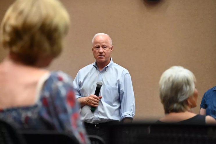Aurora Mayor Mike Coffman listens to residents during a July town hall.