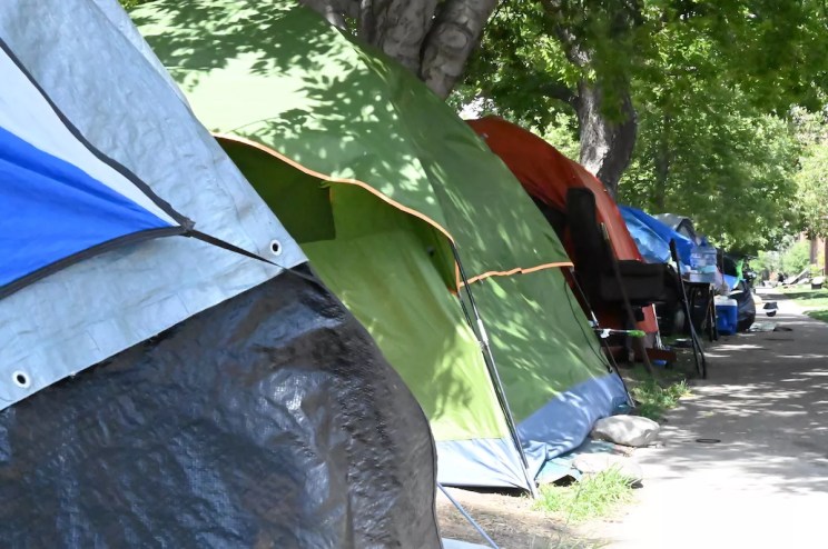 Tents line the sidewalk on the east side of Logan Street between 17th and 18th Avenue.
