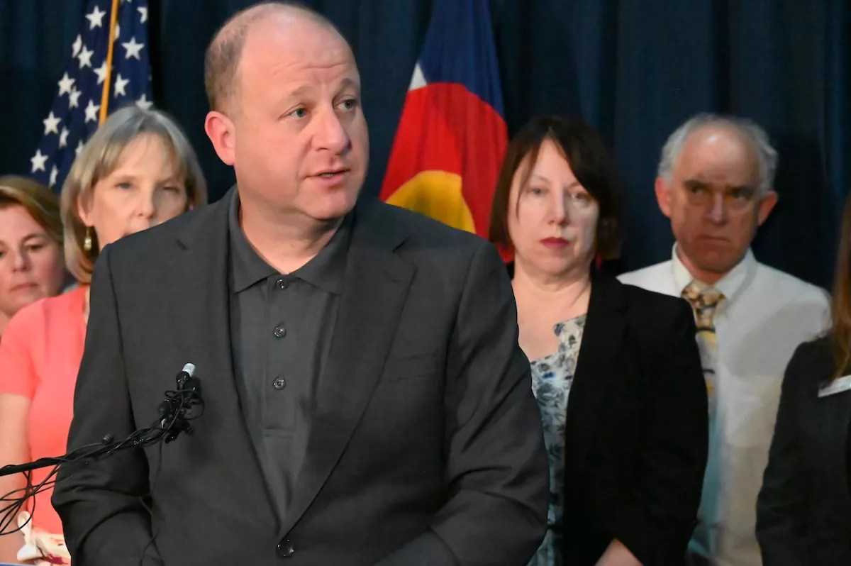 Gov. Jared Polis speaks to the press in his office on Monday, August 21.