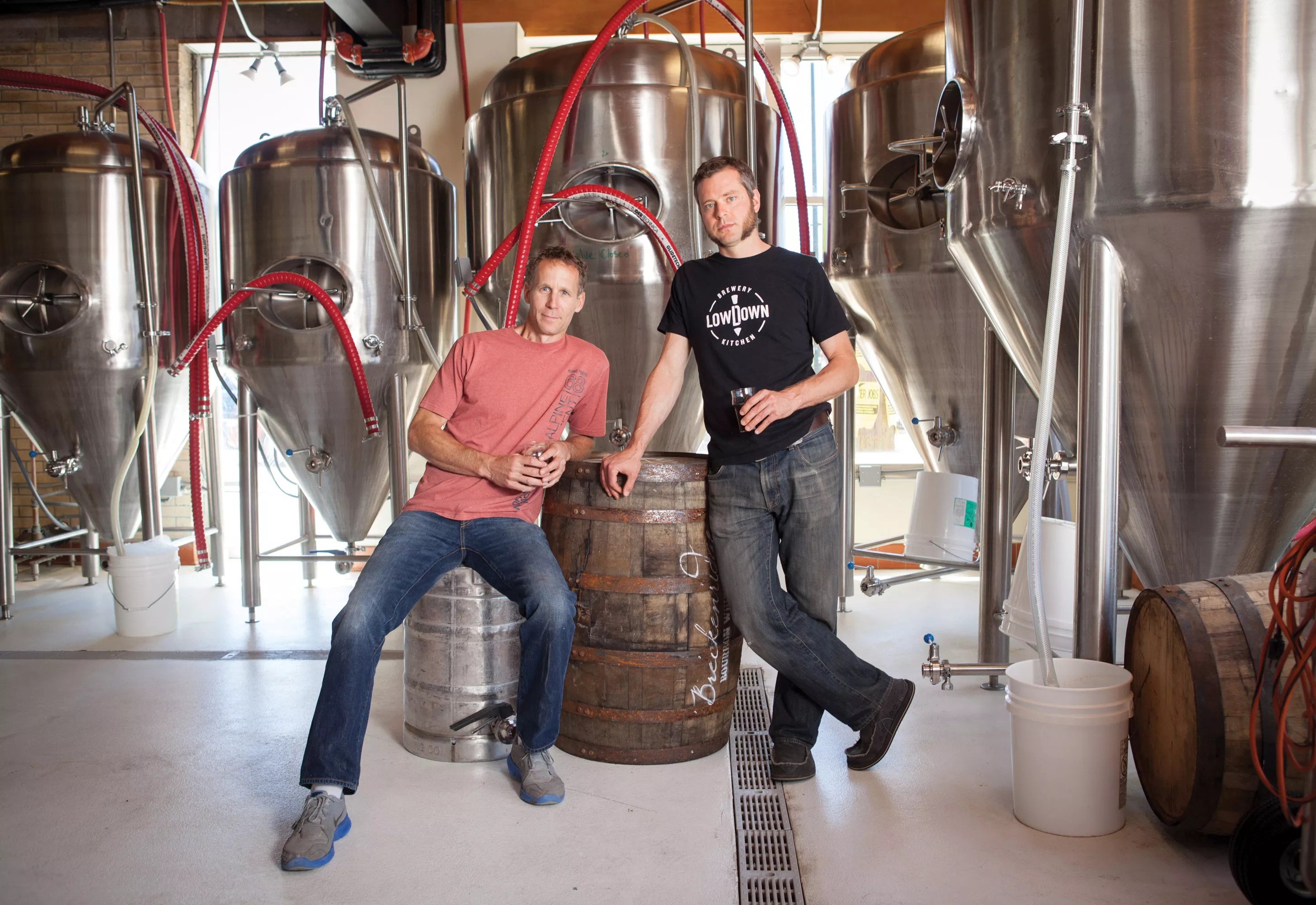 Two men standing in front of a fermenter