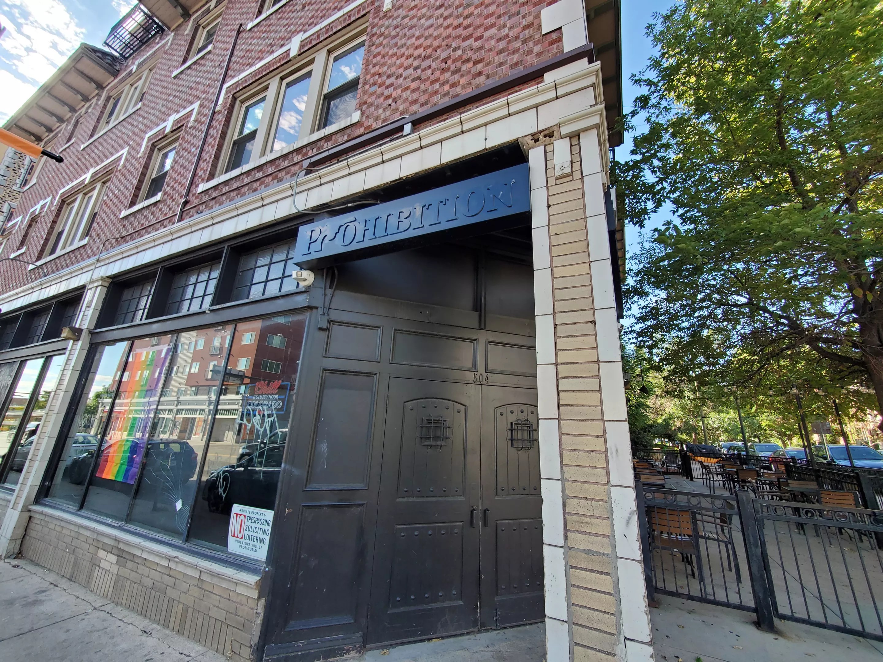 a brick building with a black doorway