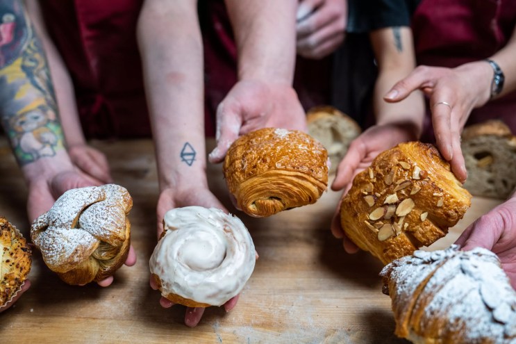 hands holding baked goods