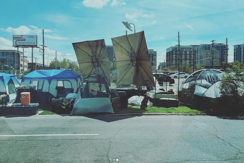 a homeless encampment with large umbrellas