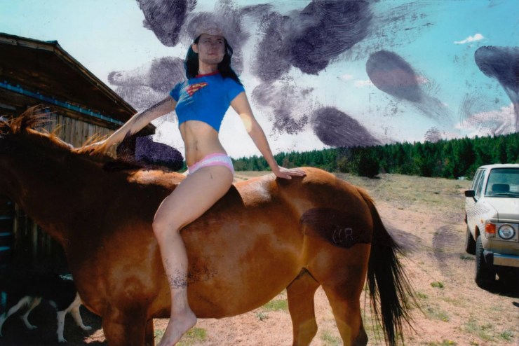 person in blue t-shirt on a horse