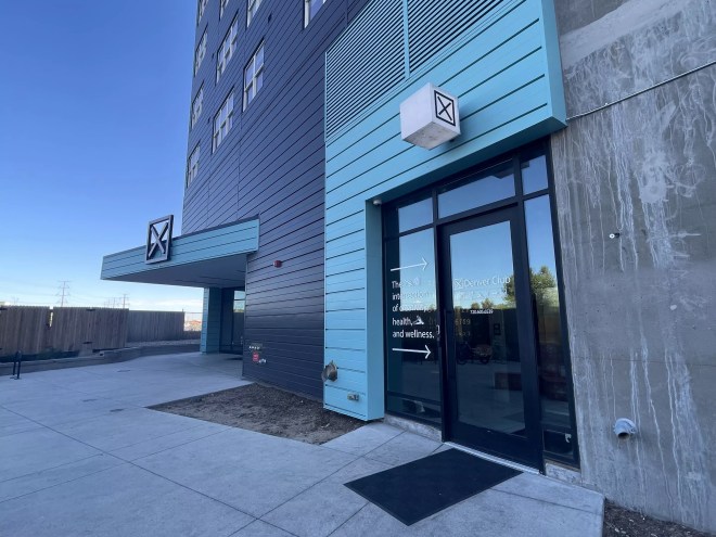 A turquoise and black building.