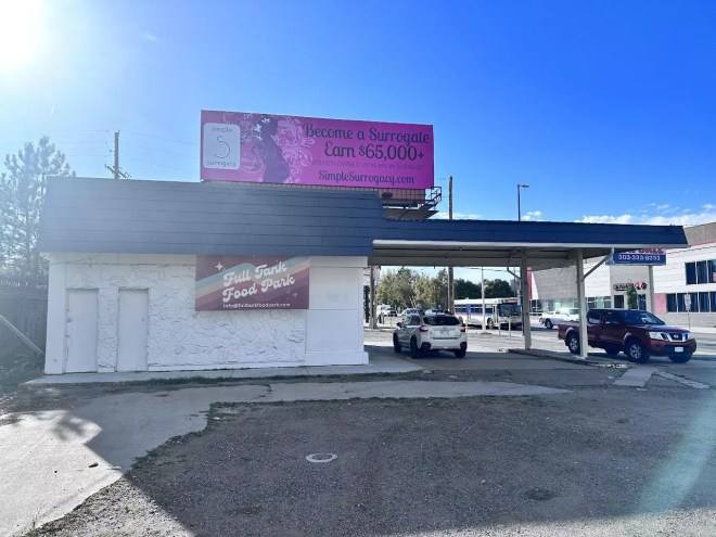 the outside of a building with a car parked under an overhang