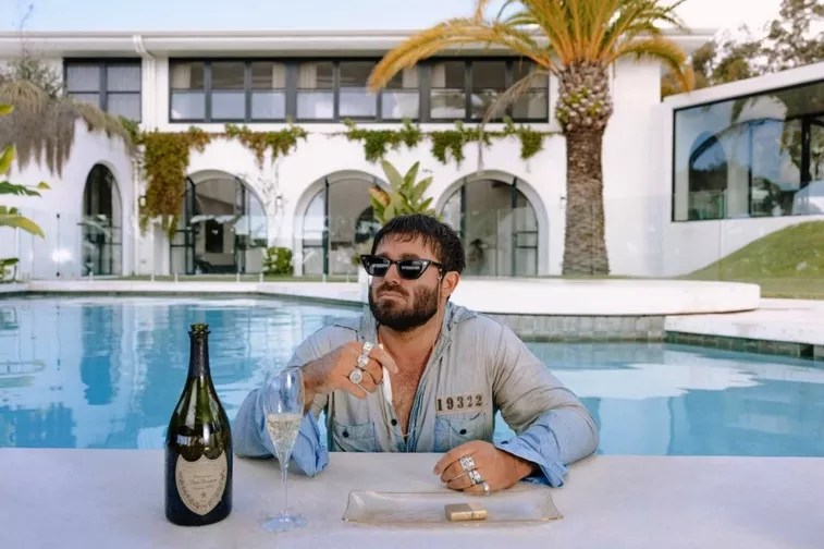 man sitting at tropical pool