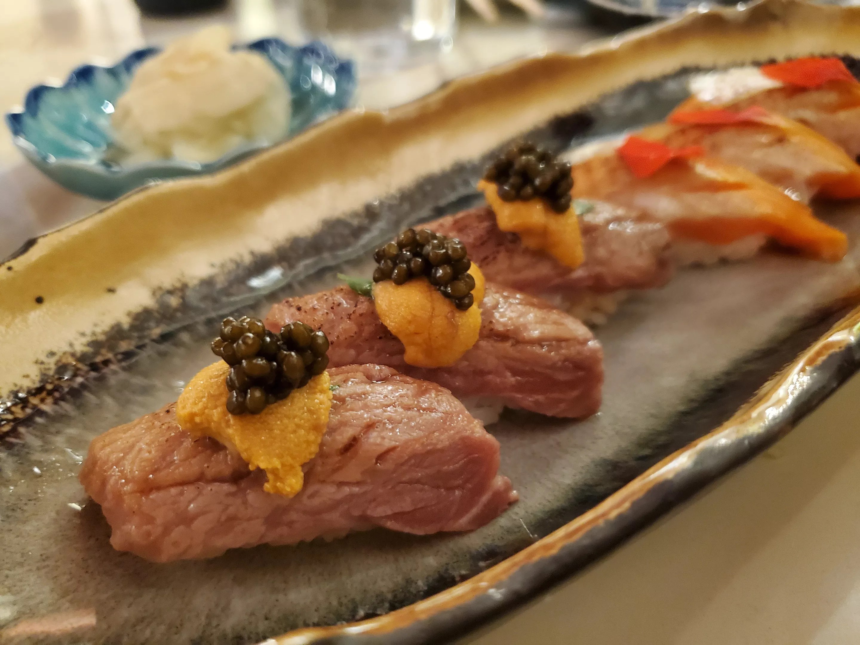 nigiri lined up on a plate