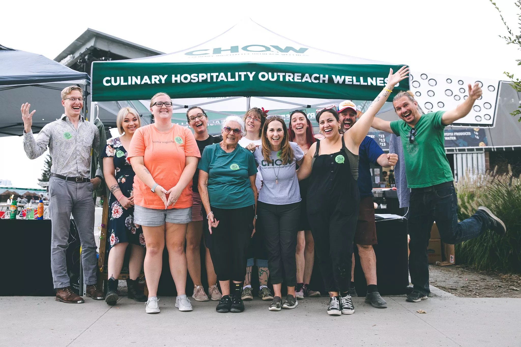 a group of people standing in front of a tent